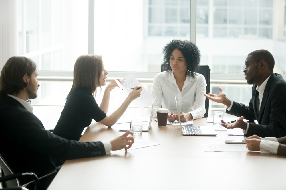 people in a boardroom discussing the legal practice management services they provide