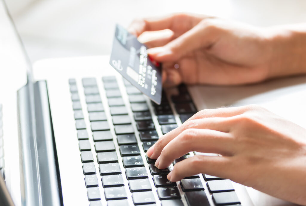 blog header image of person typing with a credit card