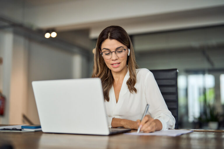 header image of bankruptcy lawyer on phone writing on paper next to laptop