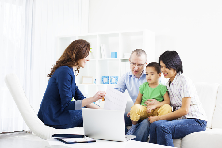 header image lawyer on desk chair talking to family sitting on couch