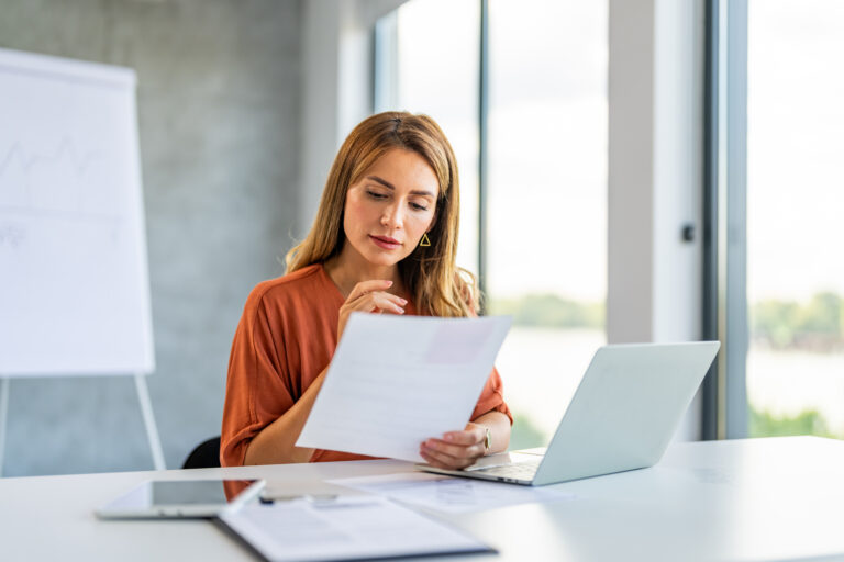 header image of female lawyer reading document at desk