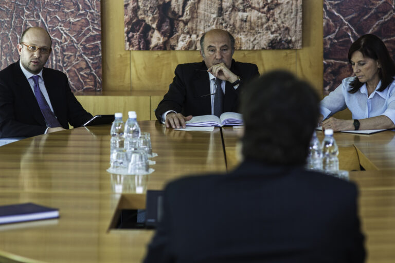 header image of lawyers sitting around conference table