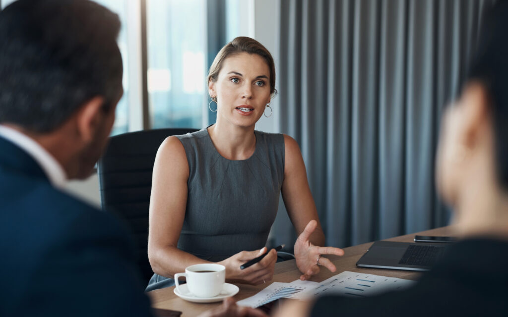 header image of lawyer behind desk talking to clients