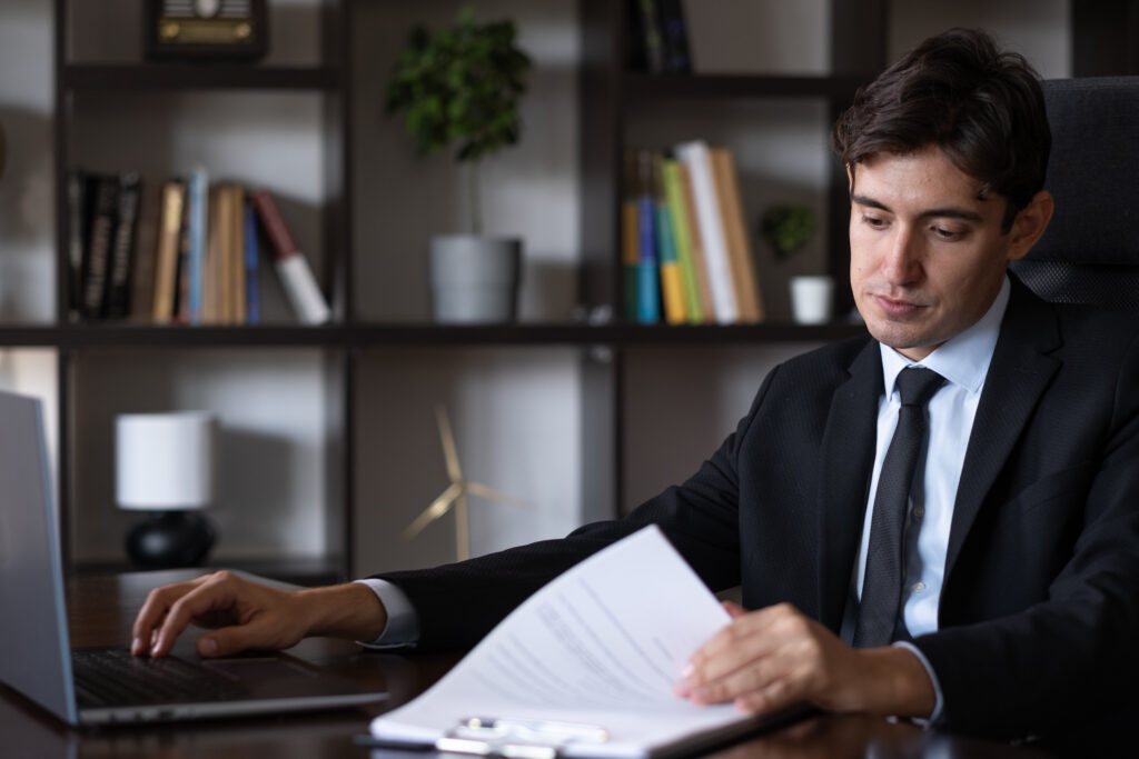 header image of lawyer behind desk flipping through pages of a document