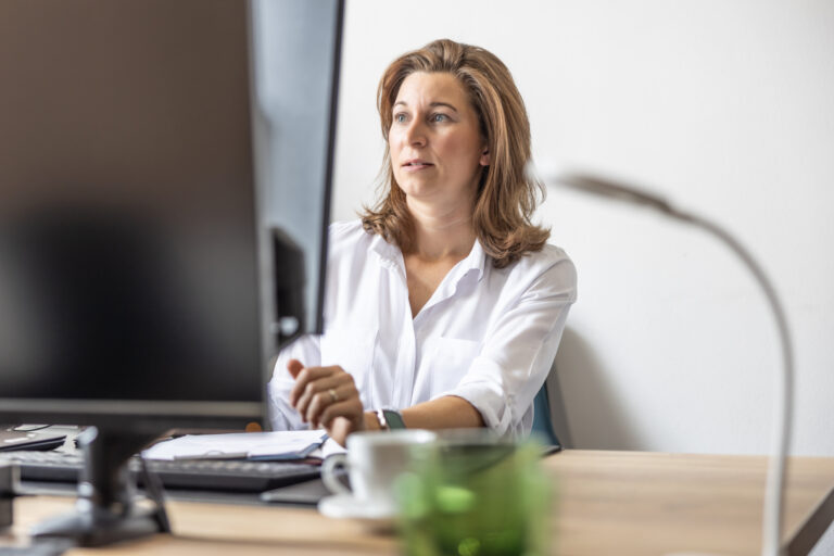 header image of lawyer sitting behind desk working on computer