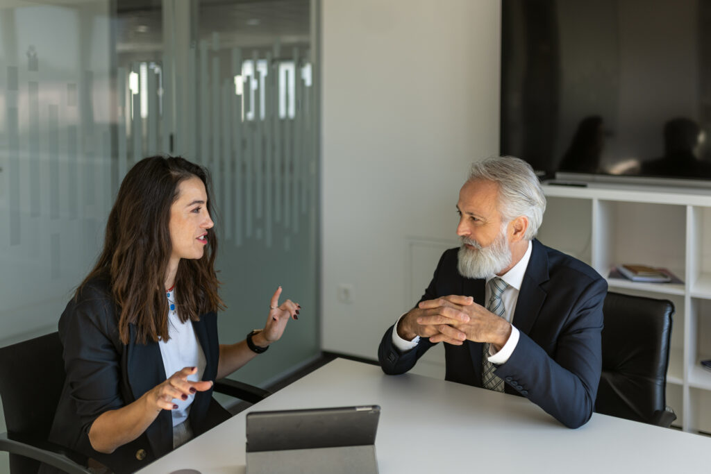 header image of two lawyers talking across a conference table