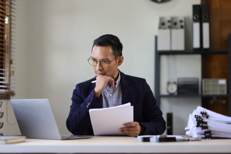 header image of lawyer sitting behind desk looking at documents