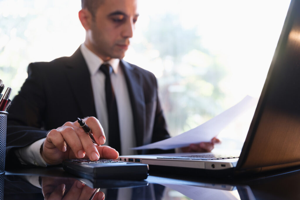 header image of lawyer working with calculator to reduce insurer fees