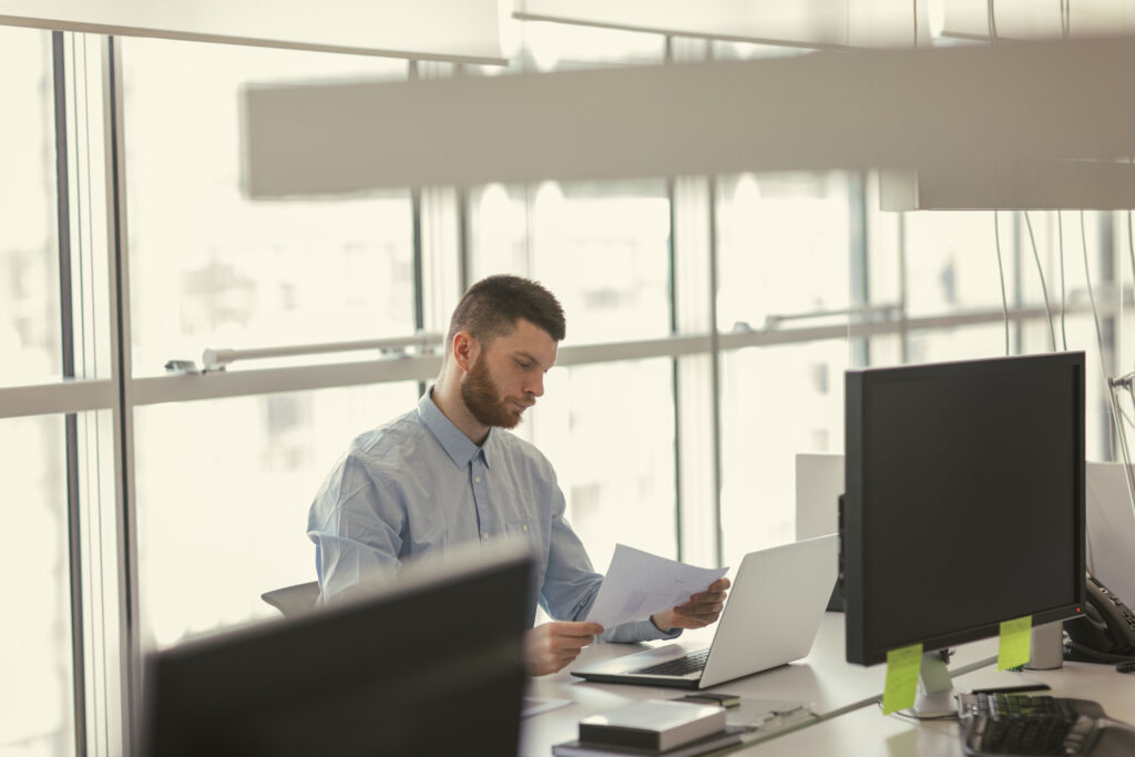 Man on computer reviewing documents