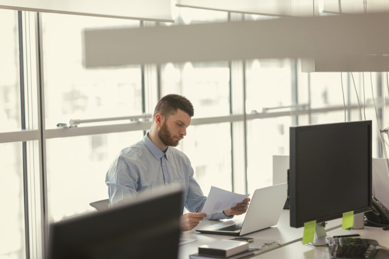 Man on computer reviewing documents