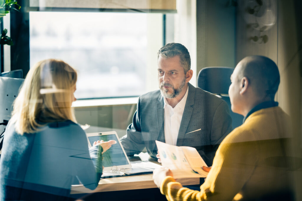 Three professionals in meeting