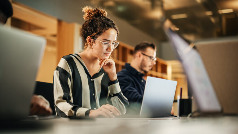 Woman in office setting working on computer