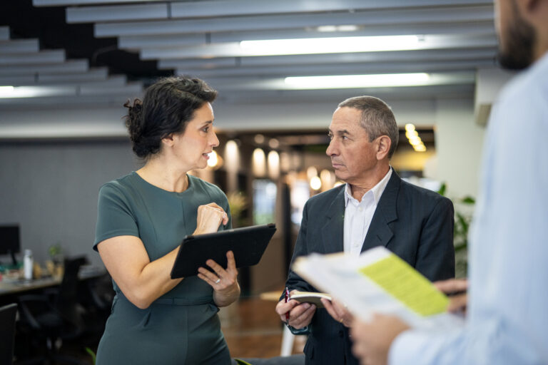 Older professional next to younger colleagues